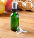 JUVITUS 2 oz Green Glass Boston Round Bottle with Black Fine Mist Spray, 12 Pack + Funnel