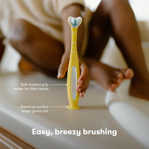 Frida Baby Triple-Angle Toothhugger Training Toddler Toothbrush, Cleans All Sides at Once, Yellow